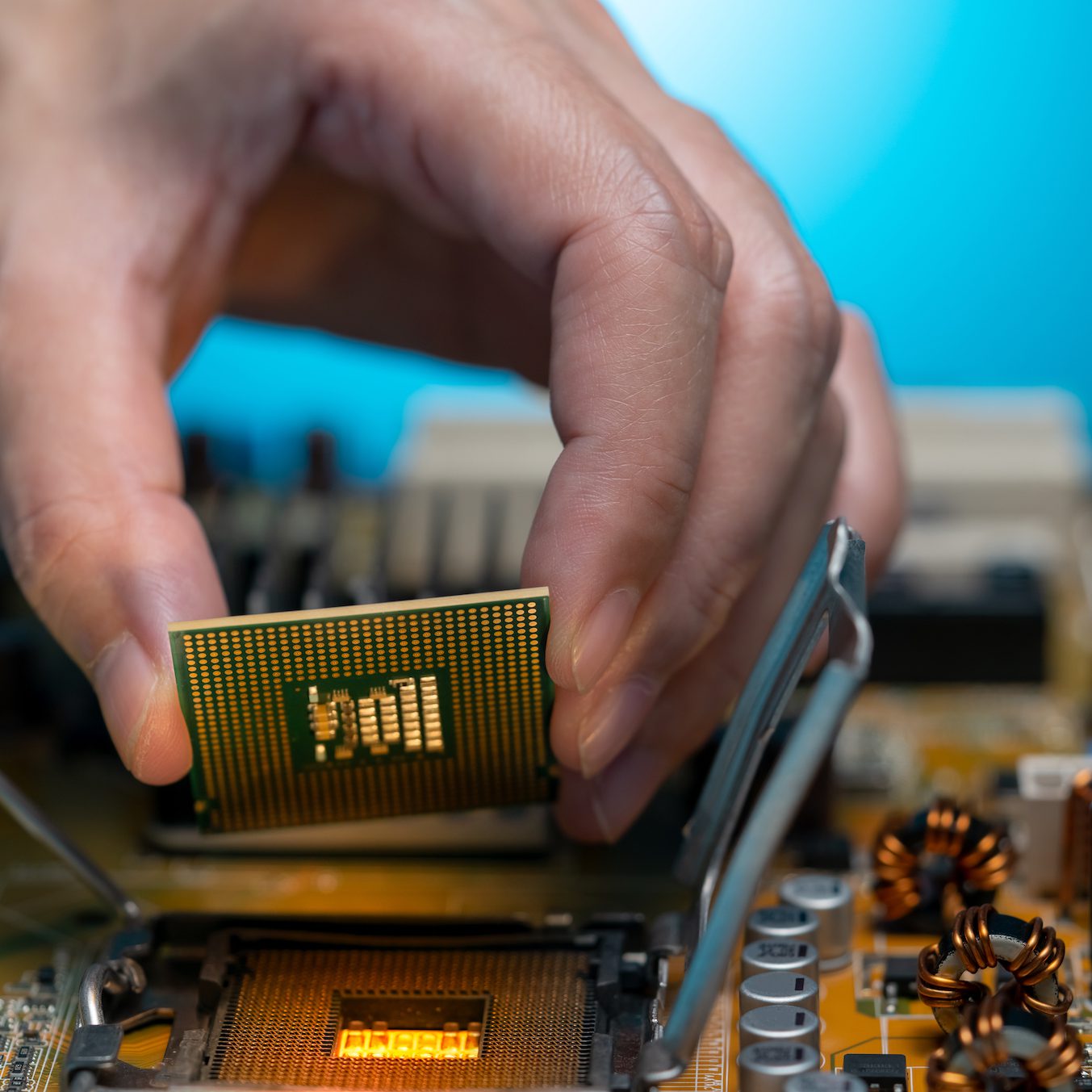 Electronic engineer hand putting computer chip on socket. Chipset on electronic circuit board of PC mother board. CPU chip. Electronic components. Computer hardware. Upgrade computer processor chip. Electronic engineer hand putting computer chip on socket. Chipset on electronic circuit board of PC mother board. CPU chip. Electronic components. Computer hardware. Upgrade computer processor chip.